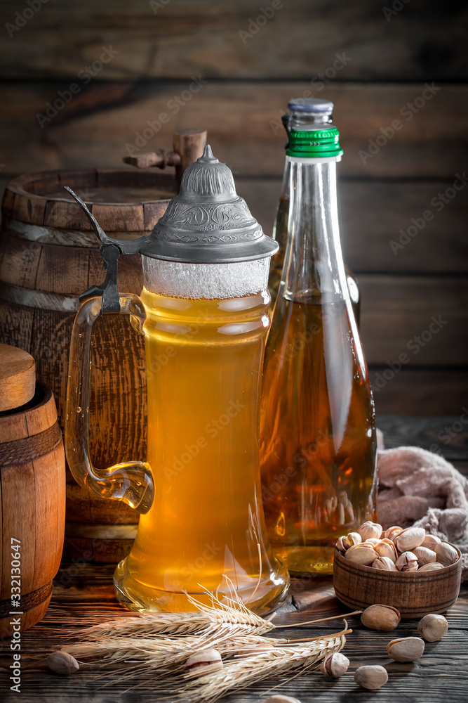Light beer in a glass, on an old background. Light beer in a glass, on an old background.