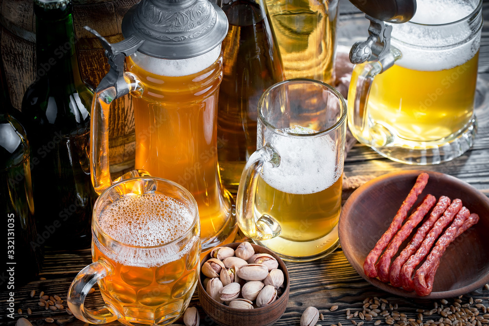 Light beer in a glass, on an old background. Light beer in a glass, on an old background.
