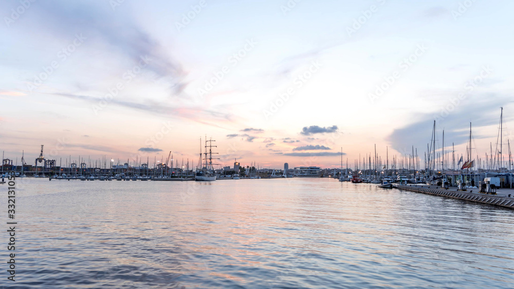 Valencia harbor, port twilight, reflection in water wide angle, panoramic skyline sunset port