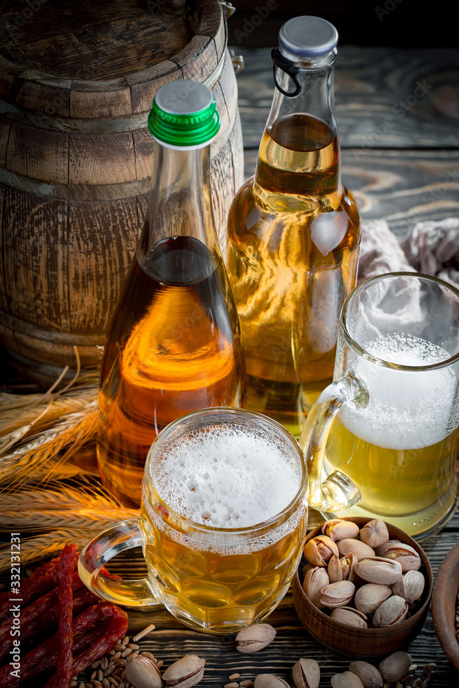 Light beer in a glass on a table in composition with accessories on an old background Light beer in a glass on a table in composition with accessories on an old background