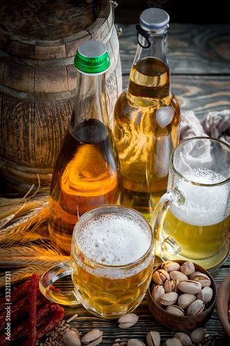 Light beer in a glass on a table in composition with accessories on an old background