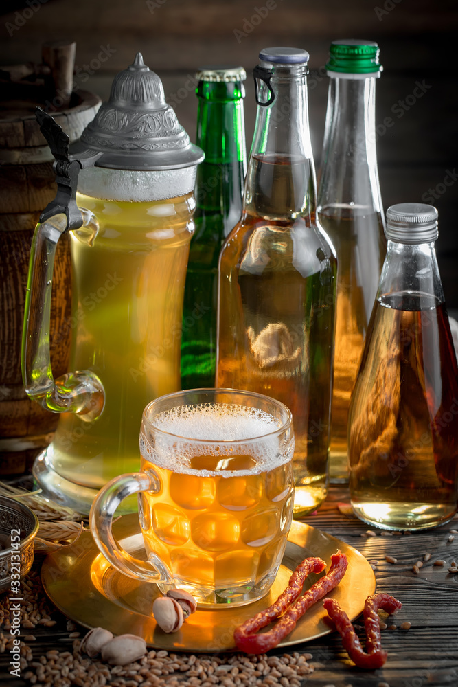 Light beer in a glass, on an old background. Light beer in a glass, on an old background.