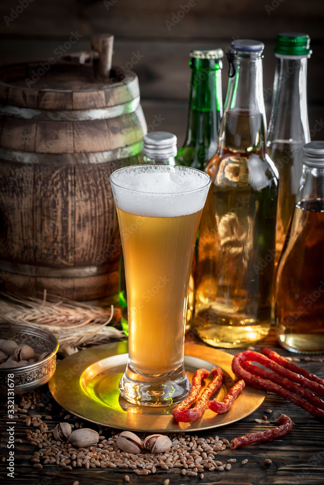 Light beer in a glass, on an old background. Light beer in a glass, on an old background.