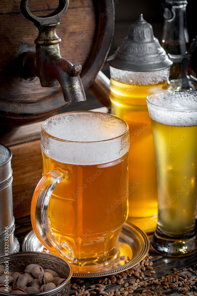 Light beer in a glass, on an old background. Light beer in a glass, on an old background.