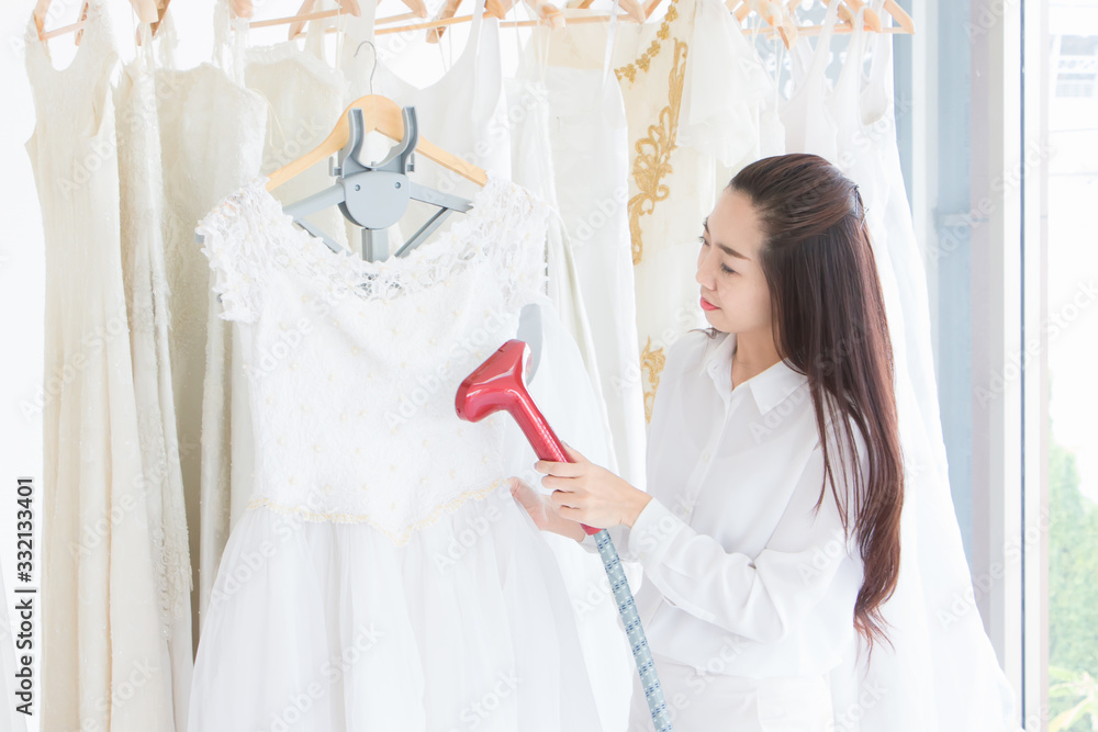 The dressmaker and the owner of her own room are ironing a wedding