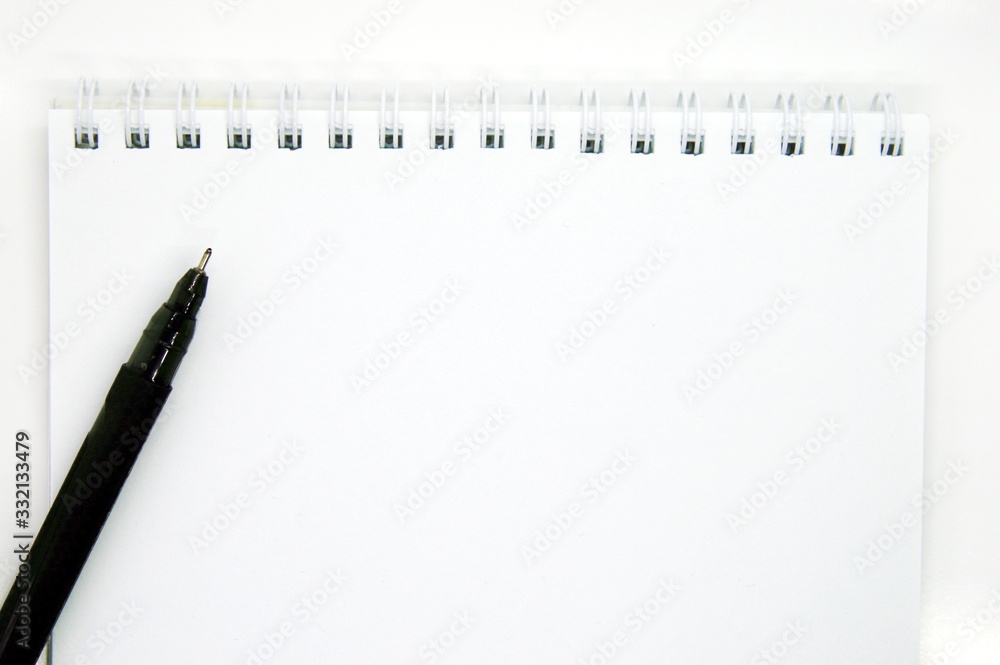 black pen and Notepad with springs on a white background black pen and Notepad with springs on a white background