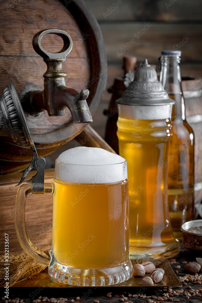 Light beer in a glass on a table in composition with accessories on an old background Light beer in a glass on a table in composition with accessories on an old background