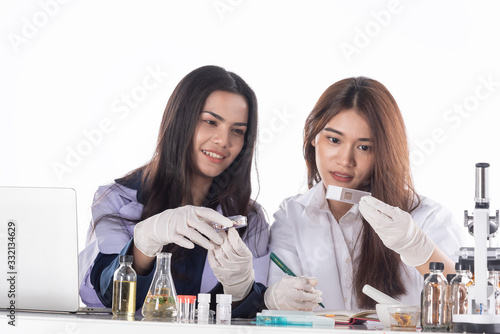 In laboratory,scientists teamwork with microscope,lab tubes,flask make test and research extraction science,chemistry and technology biology. photo