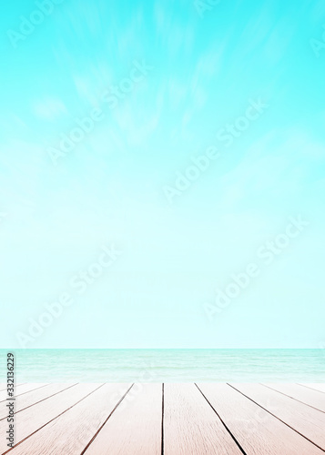 Blur cool sea background with wood floor perspective foreground on horizon tropical sandy beach for wallpaper smartphone Vertical. sky surf summer clouds and light blue wave ocean.
