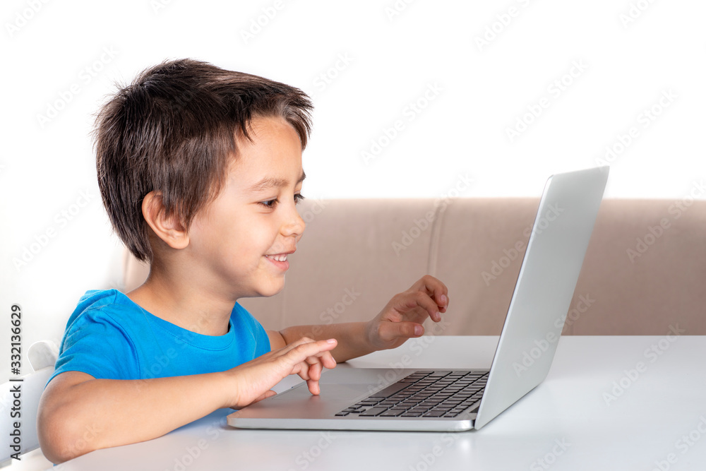 Little boy browses the internrt on a laptop. Modern lifestyle. Little boy browses the internrt on a laptop. Modern lifestyle.
