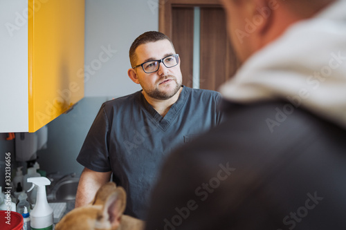 Doctor collecting an interview from a dog owner before surgery. photo