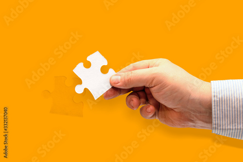 hand holding piece of jigsaw puzzle