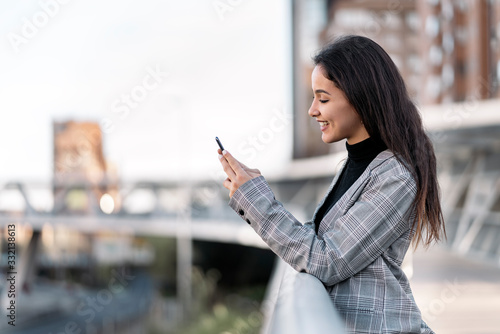 Free Download Young business woman typing with her phone - GFXLoad