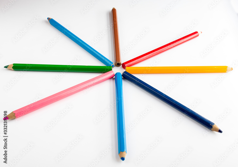 Multicolored pencils on a white background close-up. Multicolored pencils on a white background close-up.