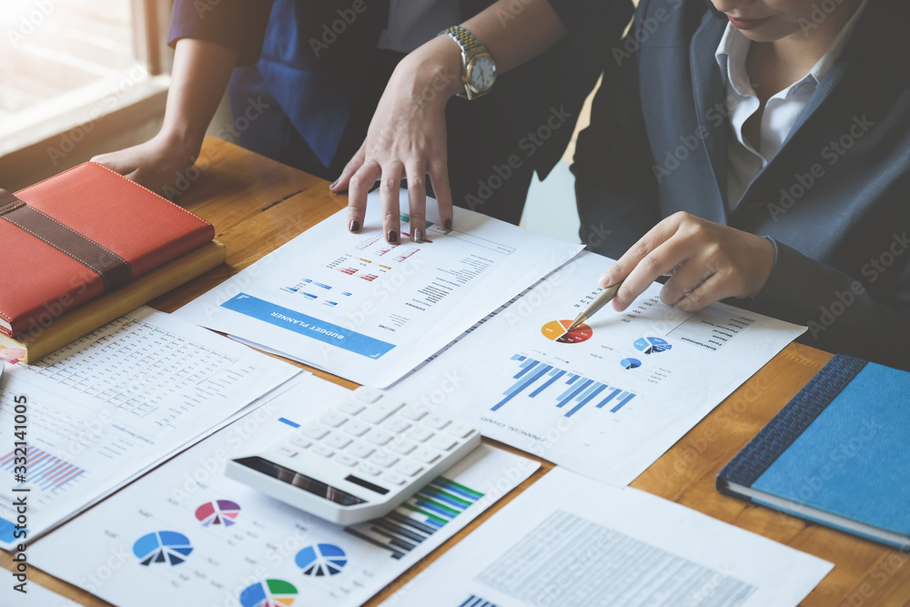 © Jirapong - A women business consultant describes a marketing plan to set business strategies for women business owners. business budget planning and researching concept.