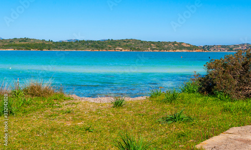 Turquoise sea and green grass in Costa Smeralda in springtime