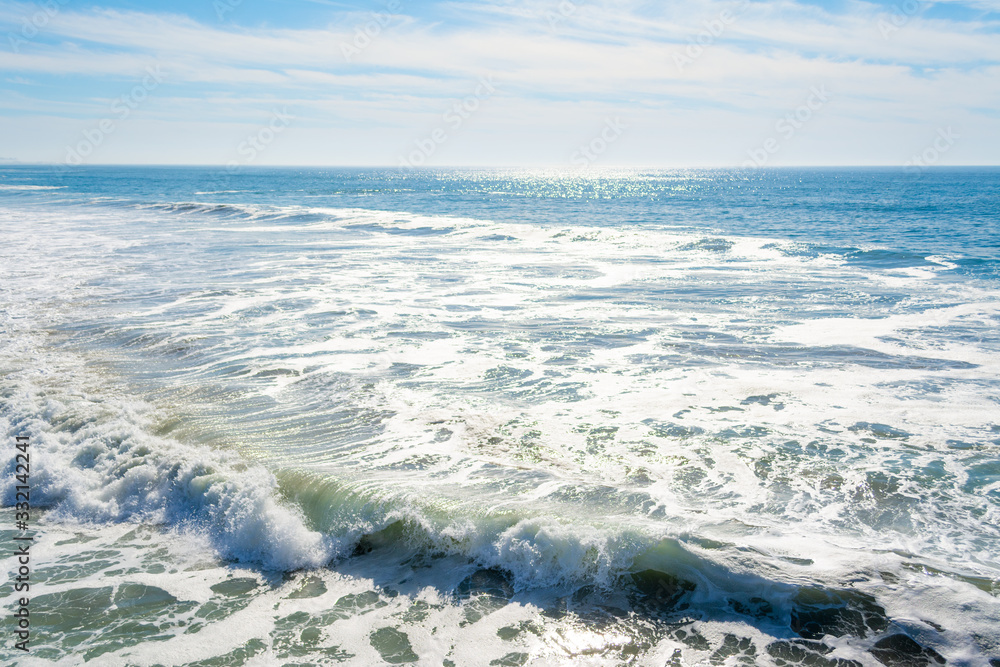 Waves in Pacific Beach shore under a sunny sky