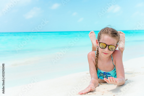 Adorable happy little girl have fun on beach vacation