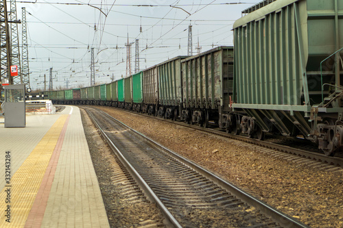 freight train standing next to the platform