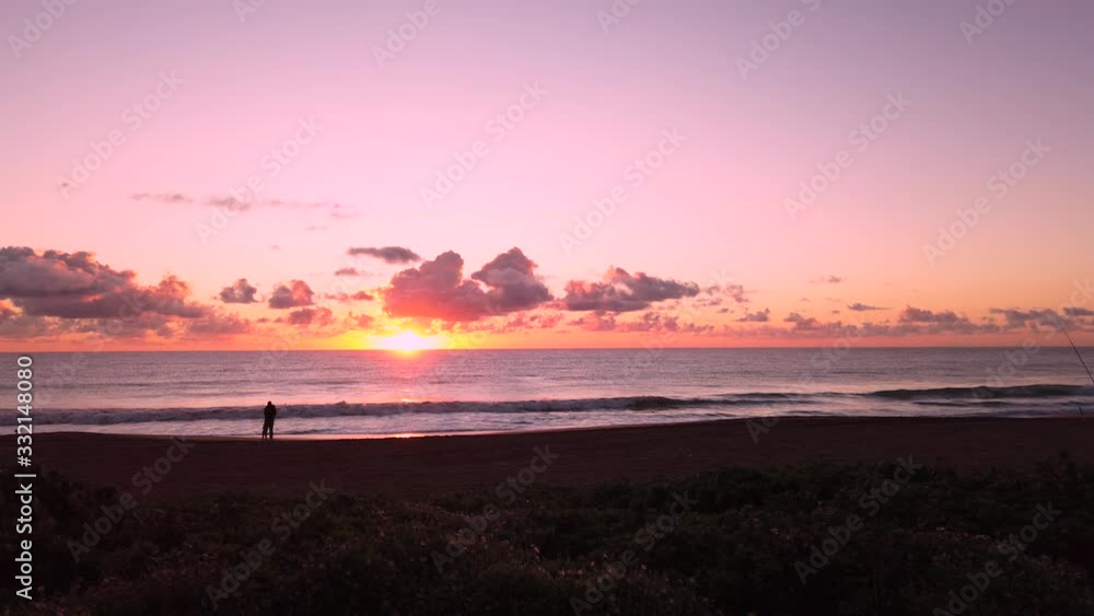 UHD Hawaii Kauai static of couple in distance on beach watching partly cloudy sunrise. Part five of five, also available as five clips in timelapse or hybrid timelapse. UHD Hawaii Kauai static of couple in distance on beach watching partly cloudy sunrise. Part five of five, also available as five clips in timelapse or hybrid timelapse.