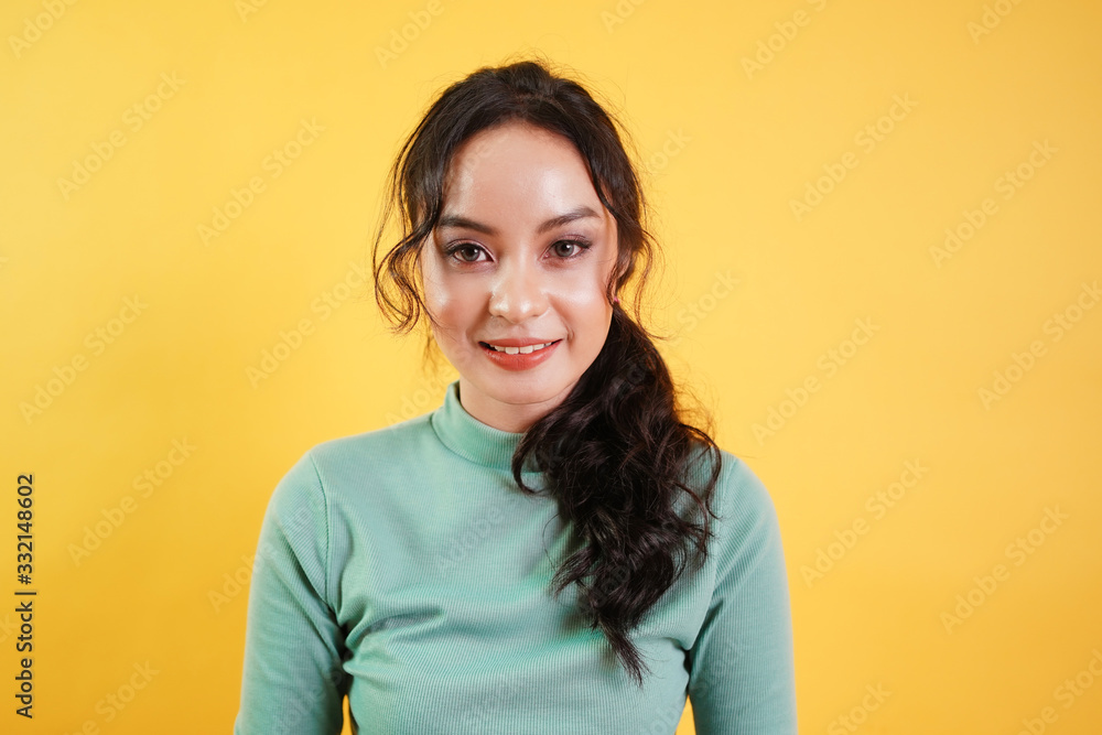 Portrait of Asian teenage beautiful cute cheerful girl smiling looking at camera over yellow background. Portrait of Asian teenage beautiful cute cheerful girl smiling looking at camera over yellow background.