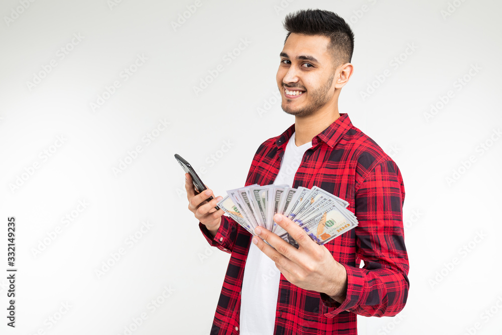 joyful adorable brunette man won the lottery and received a cash prize on a white background with copy space