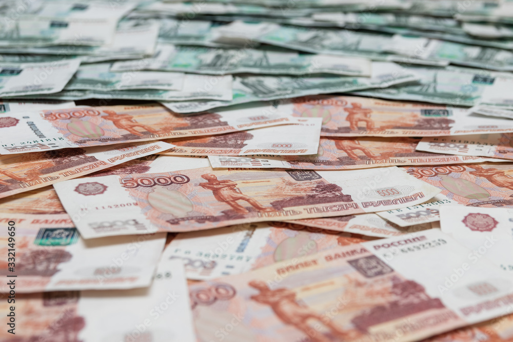 Fototapeta premium Scattered five thousandth Russian bills with thousandths in the background