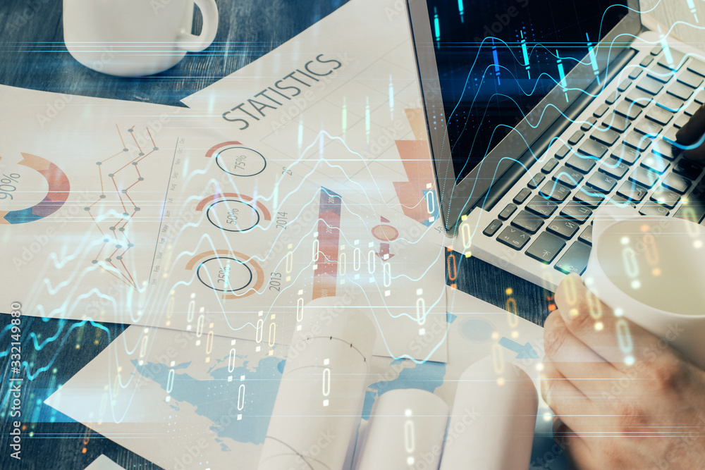 Double exposure of stock graph with businessman typing on computer in office on background. Concept of hard work. Double exposure of stock graph with businessman typing on computer in office on background. Concept of hard work.