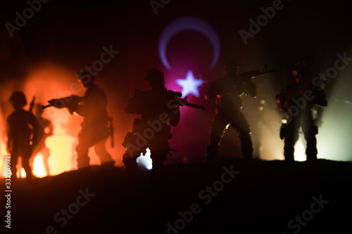 Silhouette of soldier with rifle against a turkish flag. Selective focus © zef art
