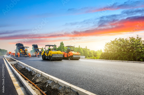 Wallpaper Mural Construction site is laying new asphalt road pavement,road construction workers and road construction machinery scene.highway construction site landscape. Torontodigital.ca