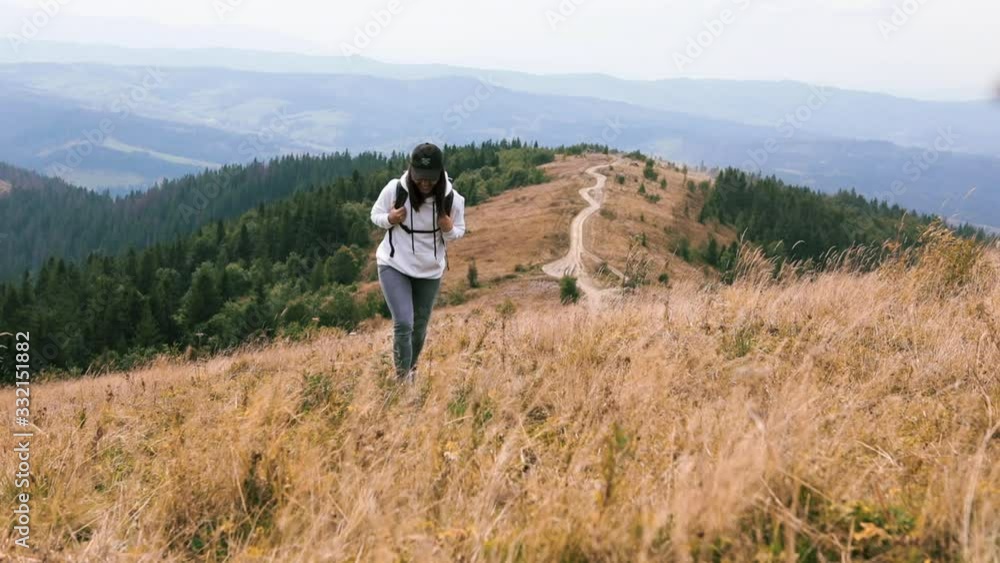 woman with backpack hiking by mountains beautiful panoramic view woman with backpack hiking by mountains beautiful panoramic view