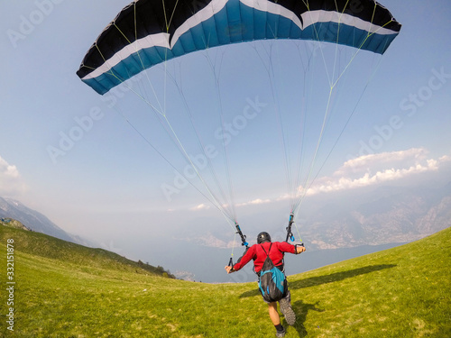 extreme paraglider flying over lago di garda