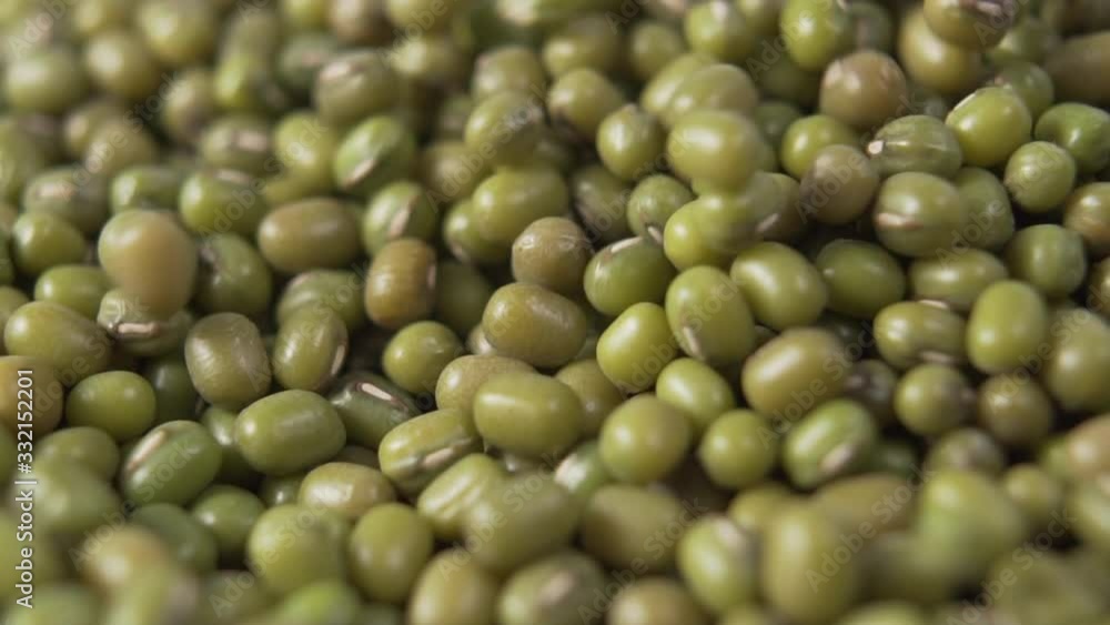 Green Mung beans fall in a pile. Slow motion. Macro Green Mung beans fall in a pile. Slow motion. Macro