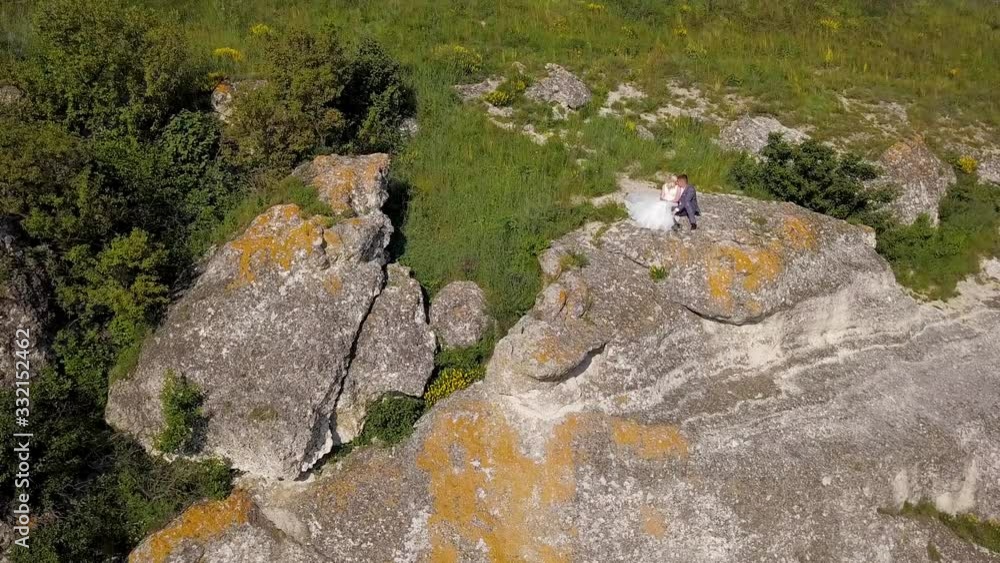 Married couple sitting on a rock Married couple sitting on a rock