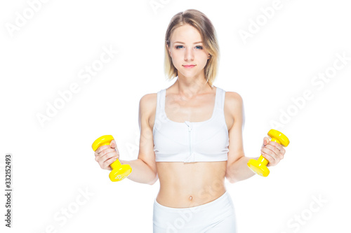 Fitness woman working out with yellow dumbbells showing her muscles on white background