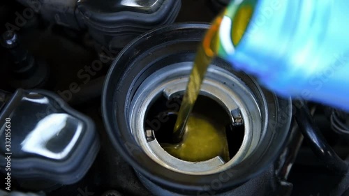 Pouring machine oil into the engine. Car service