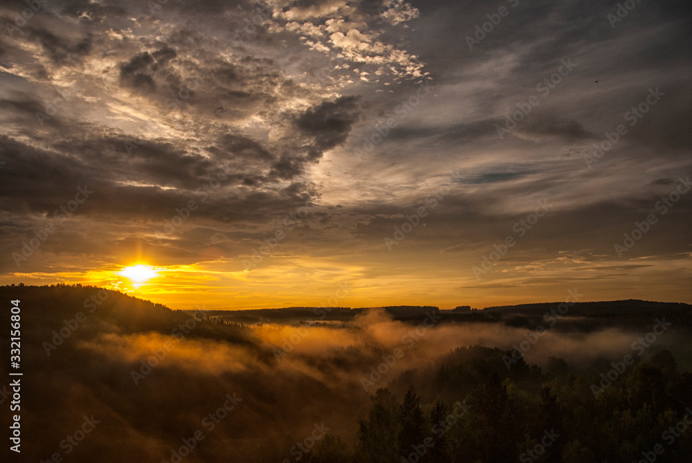 Fantastic Golden sunset with fog and clouds