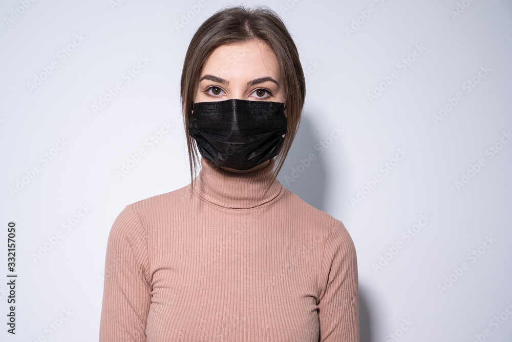 a girl in black clothes putting a black medicinal mask a girl in black clothes putting a black medicinal mask