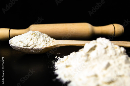 Flour, rolling pin, wooden spoon