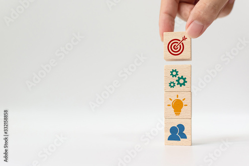 Concept of business strategy and action plan. Hand putting wooden cube block stacking with icon on white background