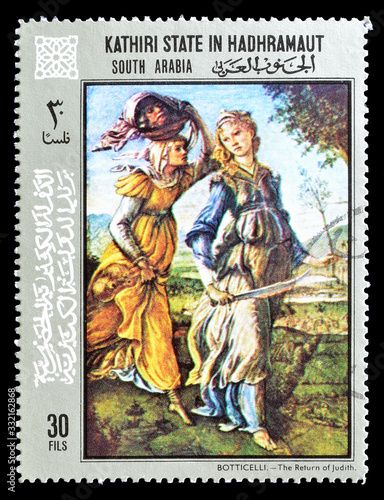 Cancelled postage stamp printed by Kathiri State in Hadhramaut, that shows painting by Botticelli, circa 1972. photo