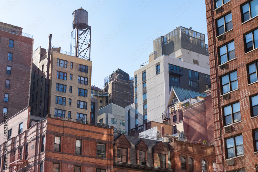Colorful Old Buildings and Skyscrapers with a Water Tower on the Upper West Side of New York City
