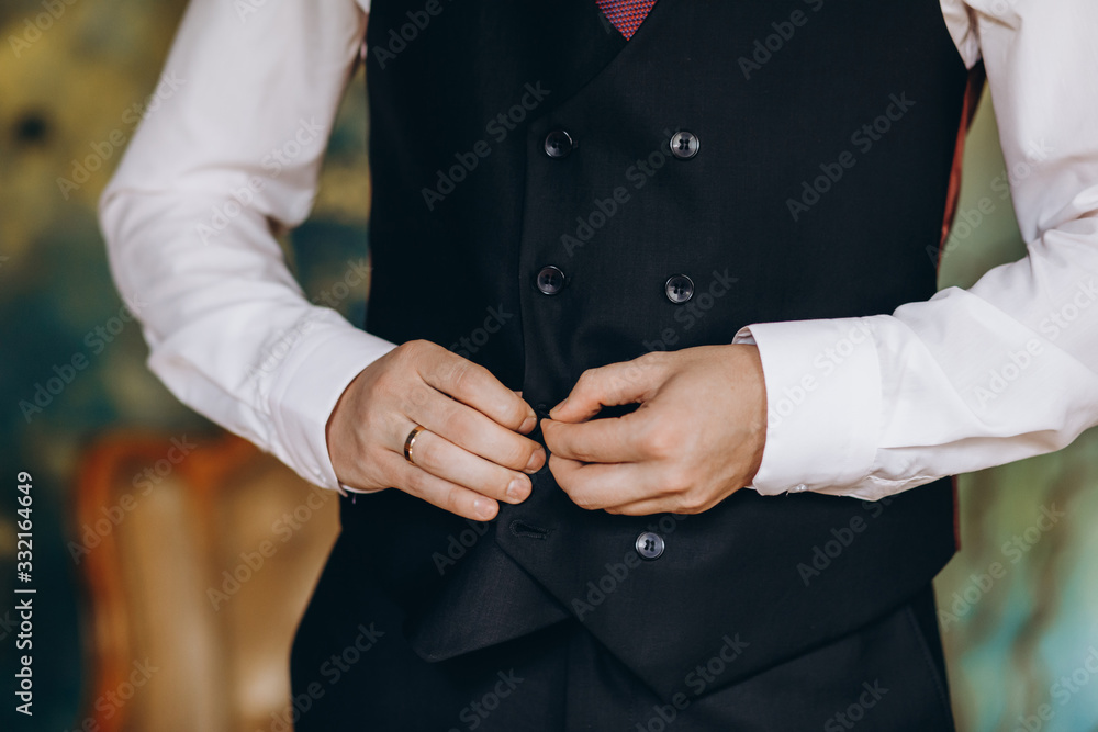 man fastens his jacket closeup