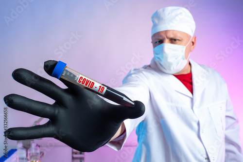 The medic holds a test tube...