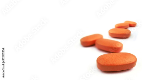 Foto Orange pills isolated on white background