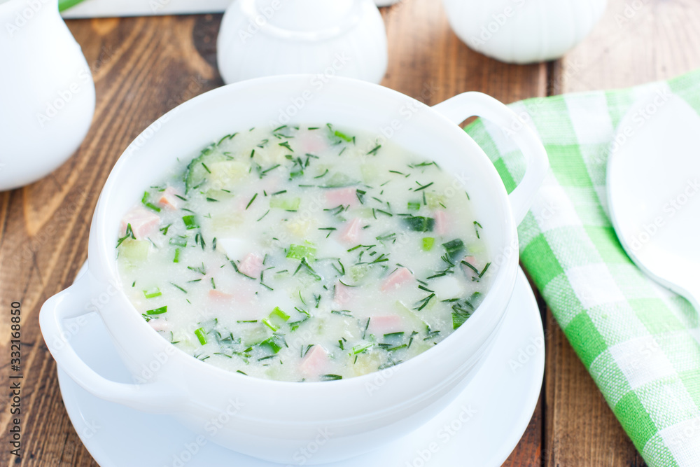 Traditional summer okroshka soup with sausage in a white bowl, selective focus Traditional summer okroshka soup with sausage in a white bowl, selective focus