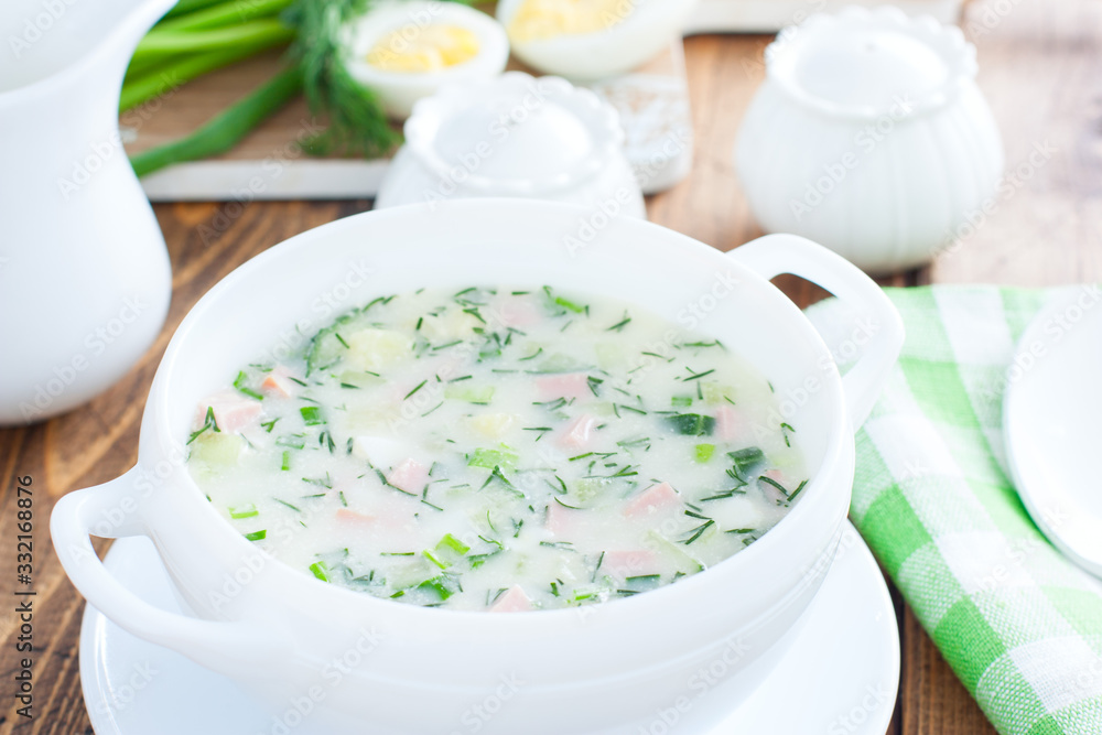 Traditional summer okroshka soup with sausage in a white bowl, selective focus Traditional summer okroshka soup with sausage in a white bowl, selective focus
