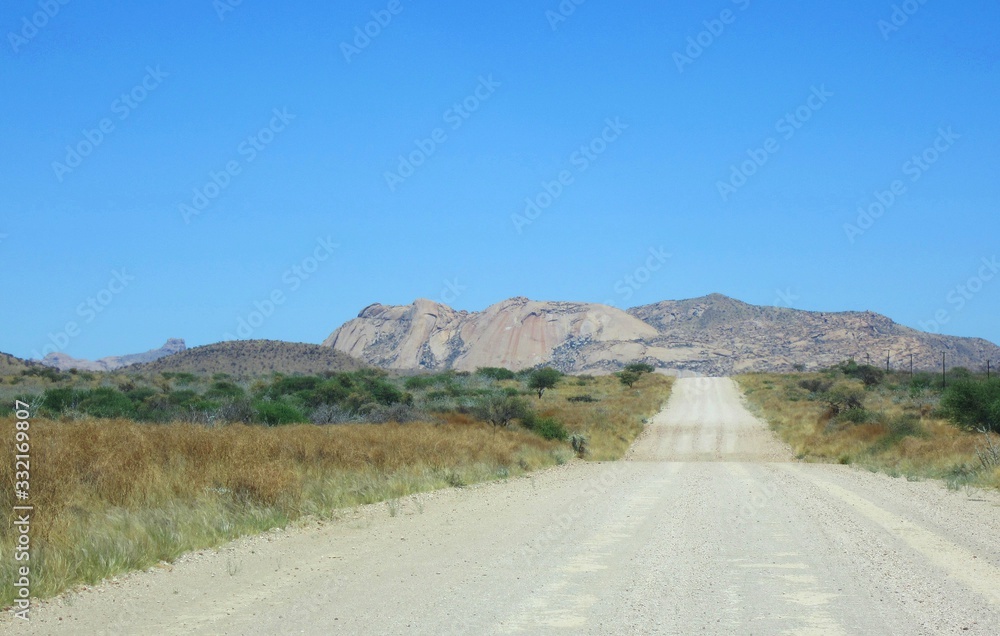 Endless gravel road through the Namibian desert