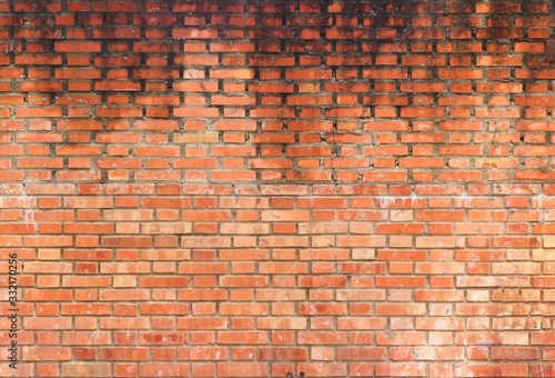 big old wet wall with water dripping from up to down on the orange bricks - background texture