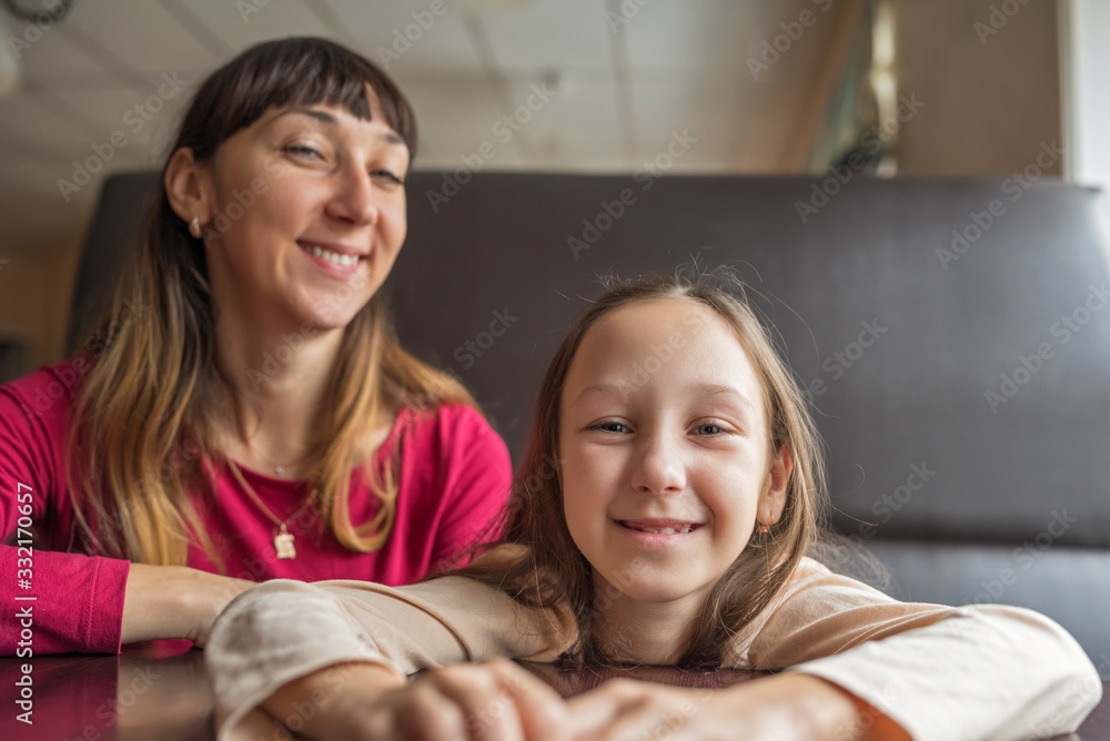 Portrait of mom with daughter in a cafe. Photographed close-up. Portrait of mom with daughter in a cafe. Photographed close-up.